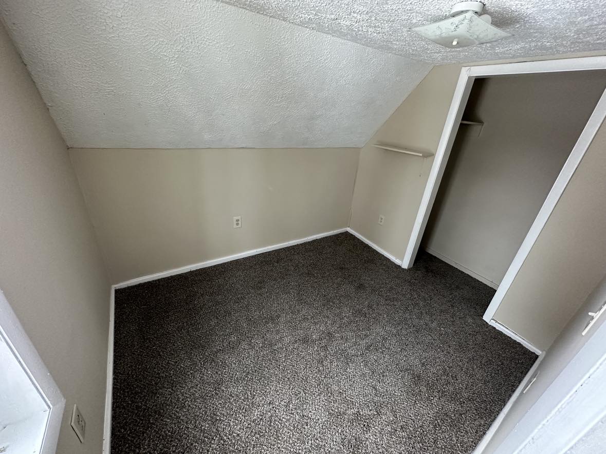 room with gray carpet