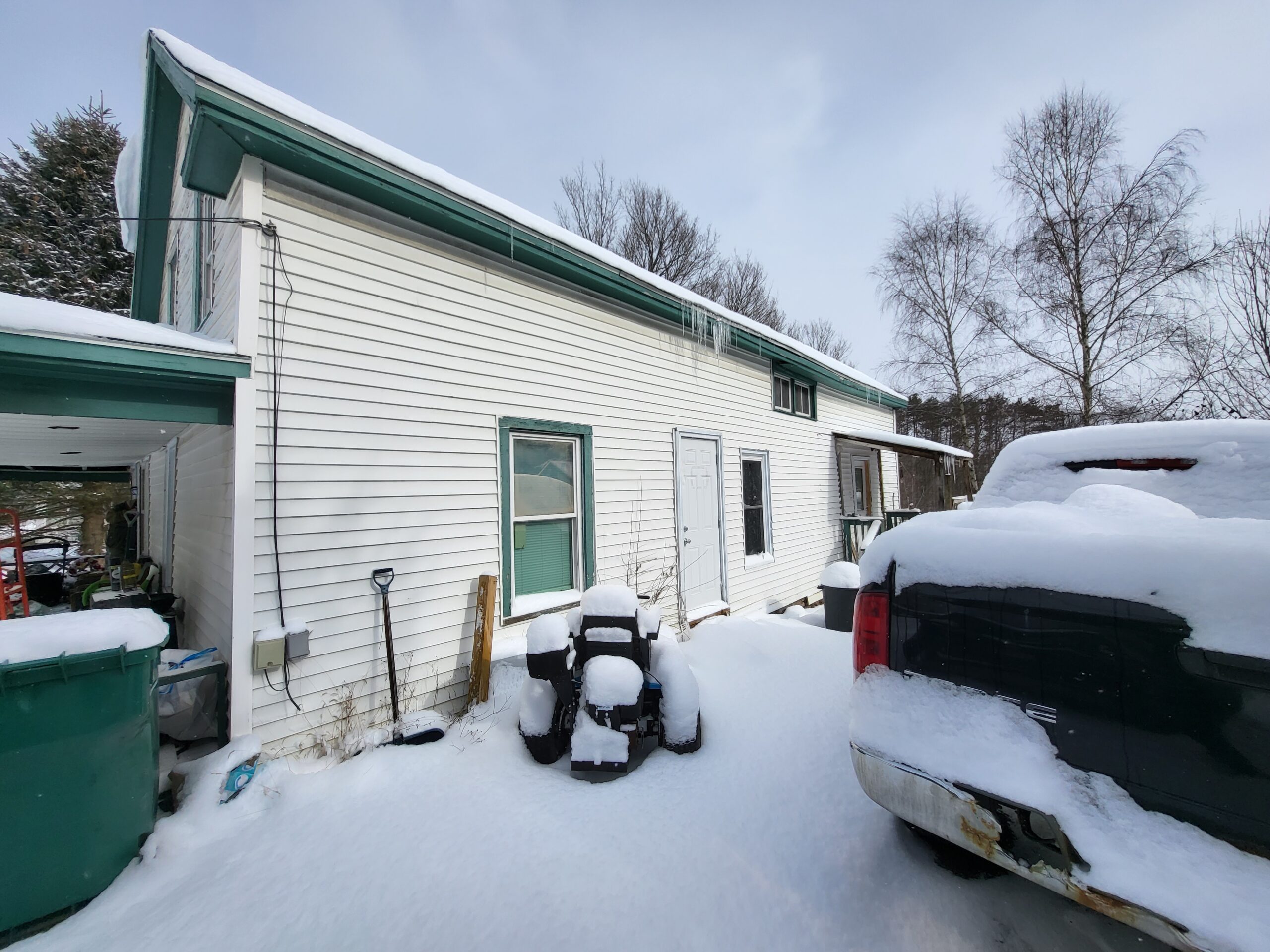 a house and car coverd in snow