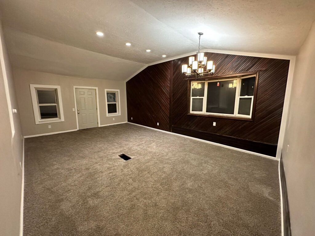 a room with a chandelier and carpet