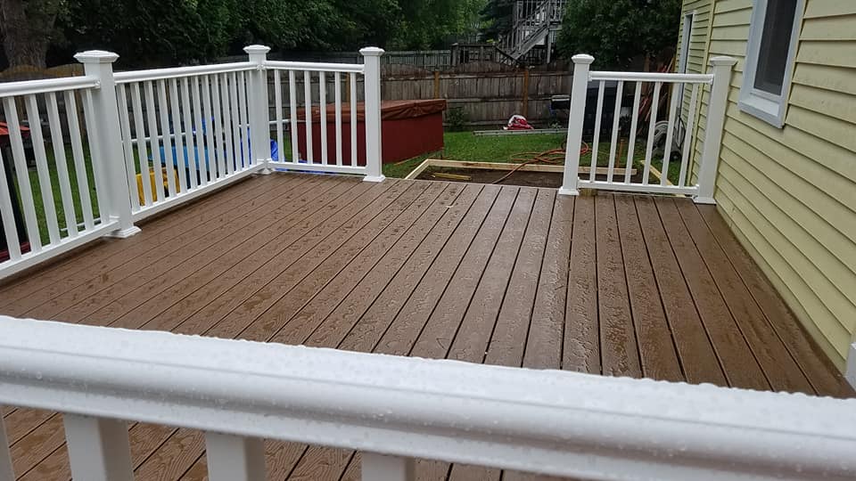 wooden deck with white walls