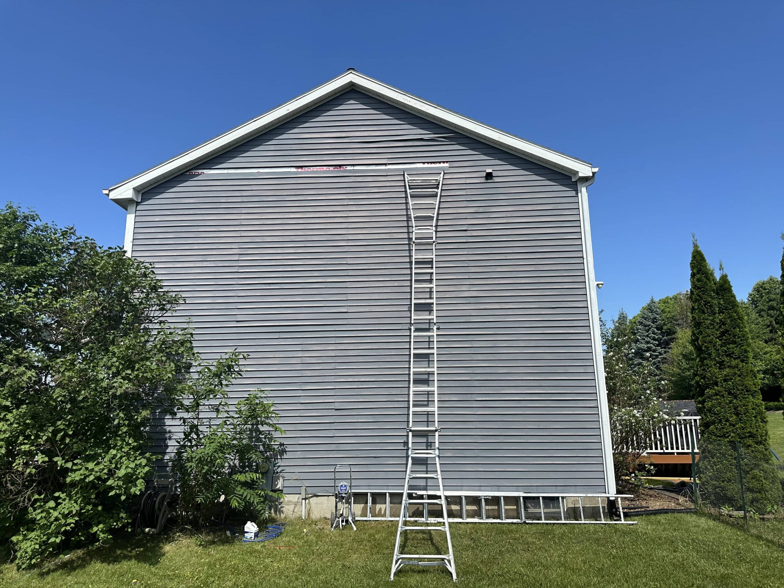 gray home with a ladder